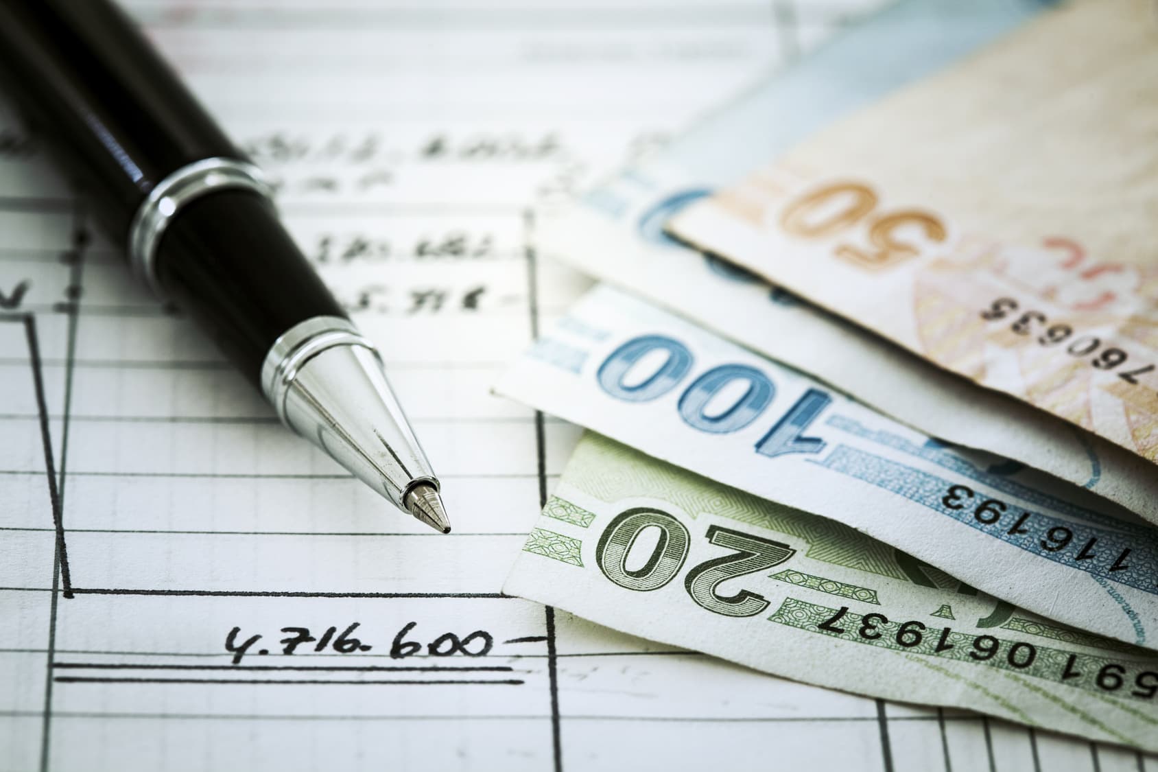 Money and pen on document